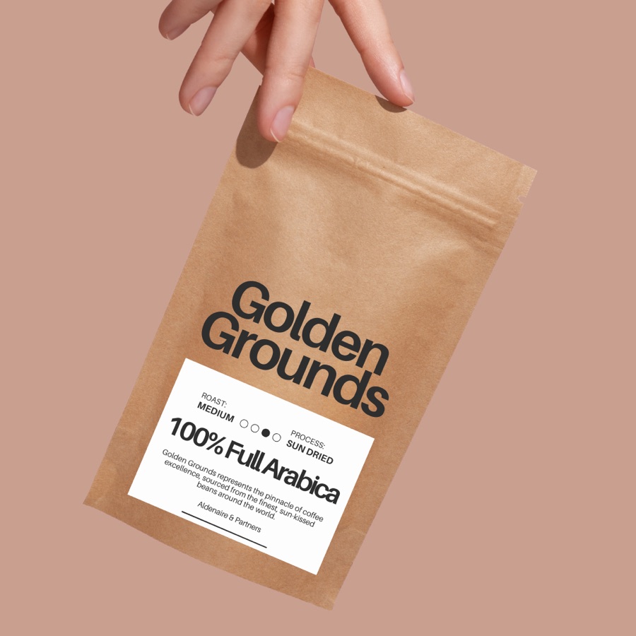 Coffee bag with a custom label, held up by hand